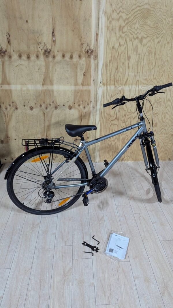 Bicicleta gris con herramientas en el suelo.