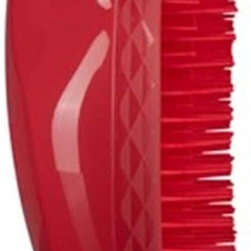 Cepillo desenredante rojo con cerdas flexibles.