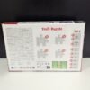 Caja de rompecabezas Trefl en mesa blanca.