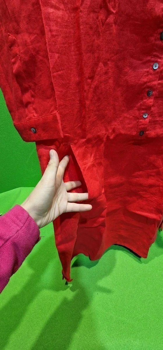 Mano muestra diseño de camisa roja brillante.