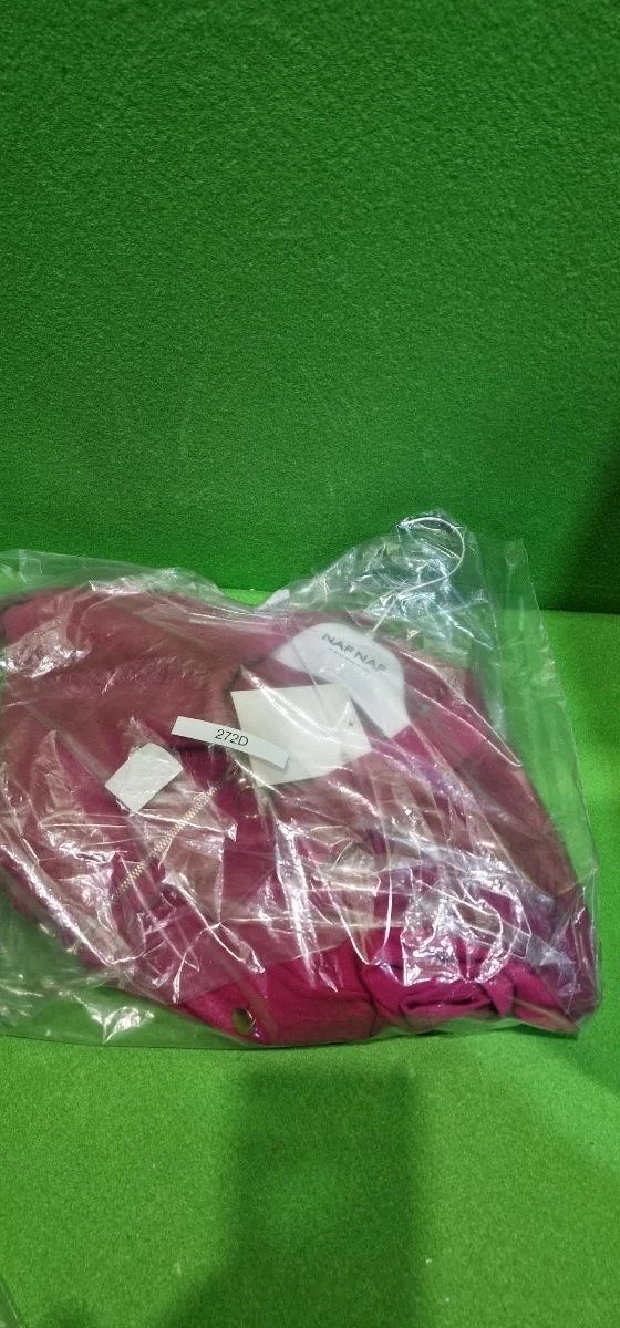 i5400926719.webp Vestido rosa embolsado sobre fondo verde