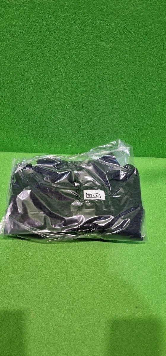 Paquete de sudadera negra en fondo verde